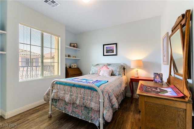 bedroom with dark hardwood / wood-style floors