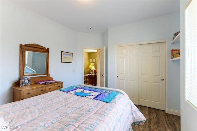 bedroom with dark hardwood / wood-style floors and a closet