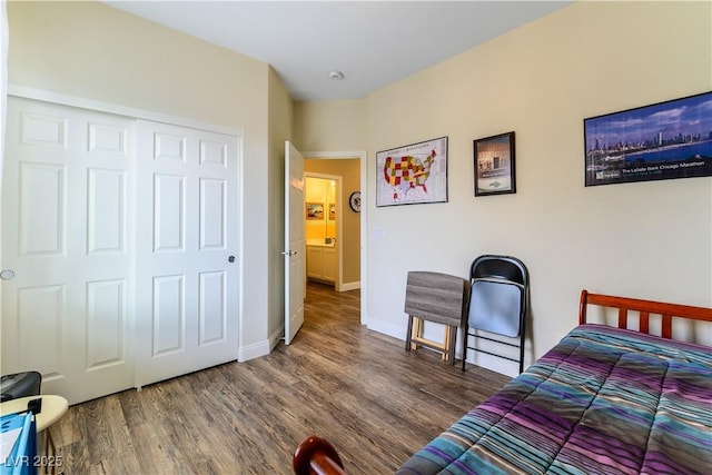 bedroom featuring dark wood-type flooring and a closet