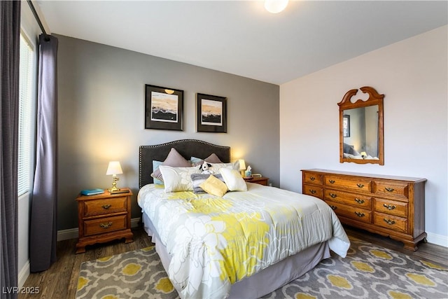 bedroom with dark hardwood / wood-style flooring