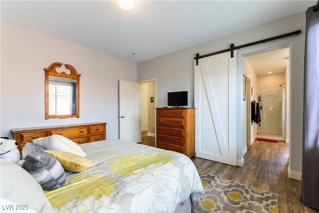 bedroom featuring dark hardwood / wood-style flooring and a barn door