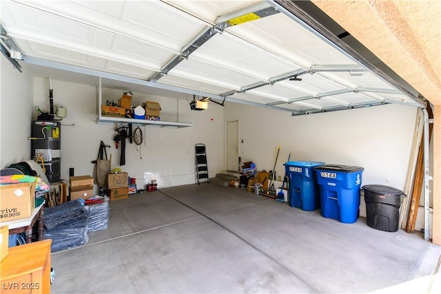 garage with a garage door opener and strapped water heater