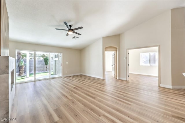 unfurnished living room featuring ceiling fan, lofted ceiling, and light hardwood / wood-style floors