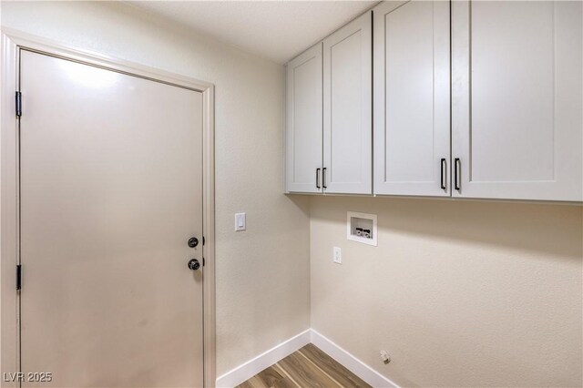 laundry area featuring cabinets, wood-type flooring, and washer hookup