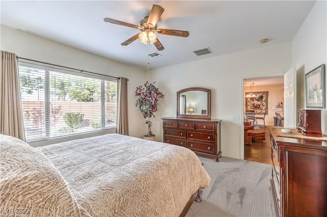 bedroom featuring light colored carpet and ceiling fan