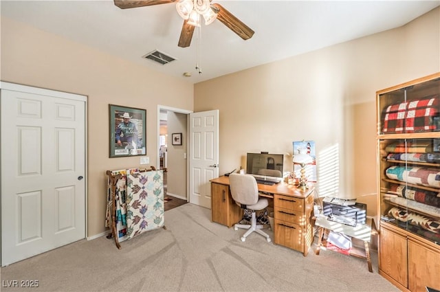 carpeted office space with ceiling fan