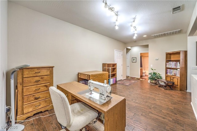 office area featuring track lighting, dark hardwood / wood-style flooring, and a textured ceiling