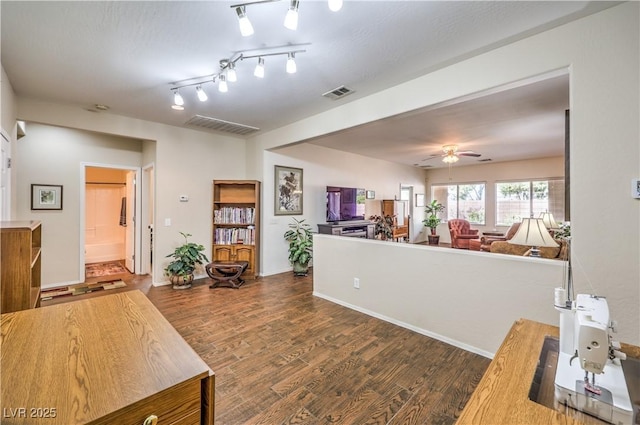 interior space featuring ceiling fan and dark hardwood / wood-style floors