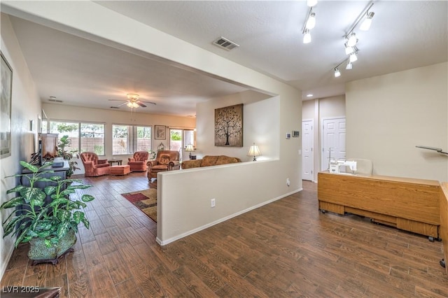 kitchen featuring ceiling fan, track lighting, and dark hardwood / wood-style flooring