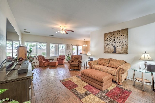 living room with hardwood / wood-style flooring and ceiling fan