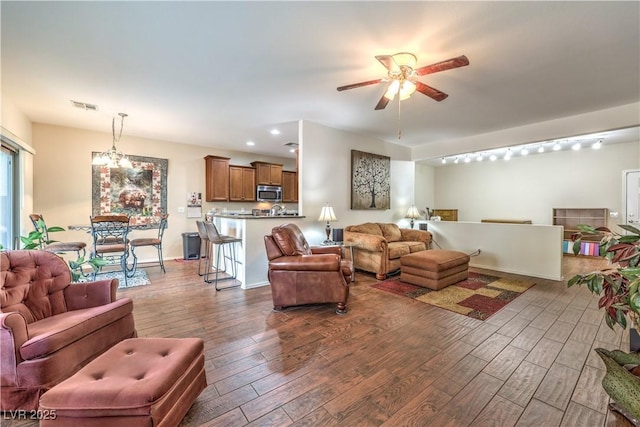 living room featuring dark hardwood / wood-style floors and ceiling fan