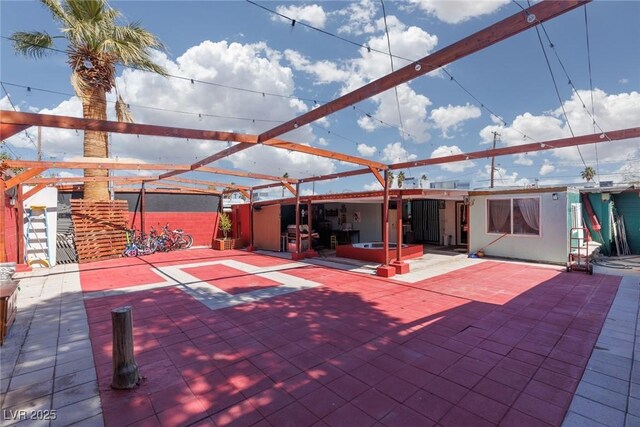 view of patio featuring a lanai and a hot tub