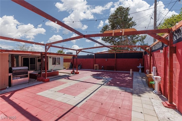 view of patio featuring a lanai and fence