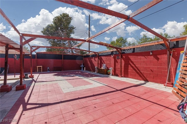 view of patio with glass enclosure and a fenced backyard