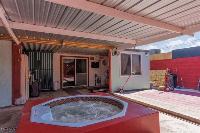 exterior space featuring a hot tub and fence