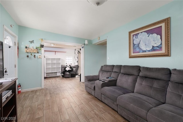 living area with light wood-style floors and baseboards