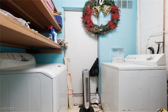 laundry room featuring washing machine and dryer and laundry area