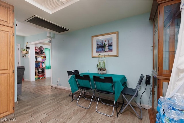 dining room with light wood-style flooring and baseboards