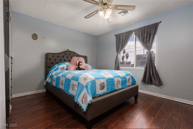 bedroom with baseboards, visible vents, a textured ceiling, and hardwood / wood-style floors