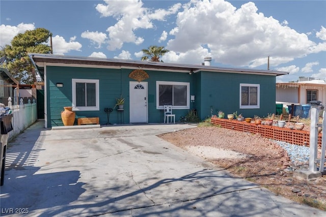 ranch-style house featuring driveway and fence