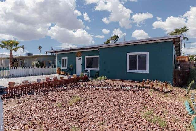 back of property featuring a patio area and fence