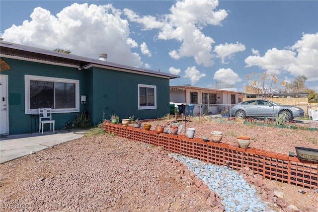 rear view of house with fence