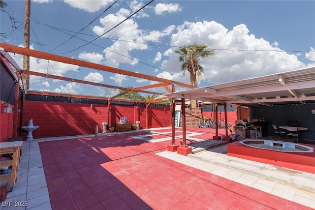 view of patio featuring fence