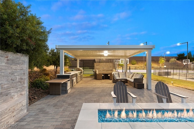 view of patio with a gazebo, an outdoor kitchen, and an outdoor living space