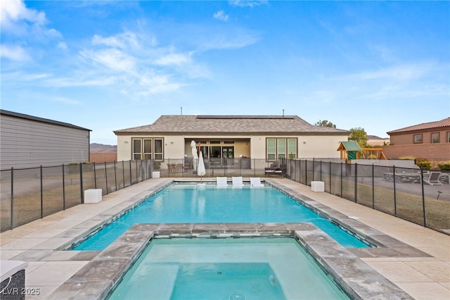 view of pool with an in ground hot tub and a patio area