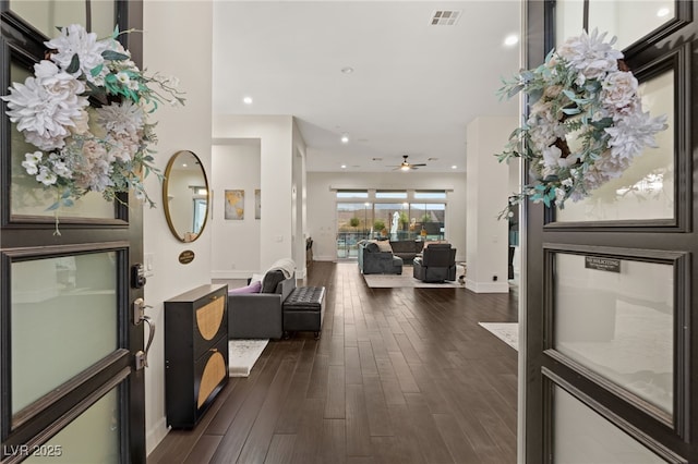 corridor with dark hardwood / wood-style flooring