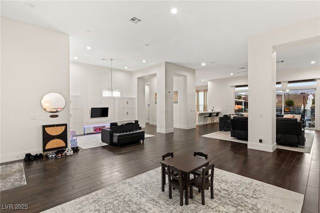 living room featuring dark hardwood / wood-style flooring and a notable chandelier