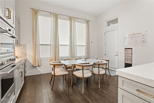 dining space featuring dark hardwood / wood-style floors