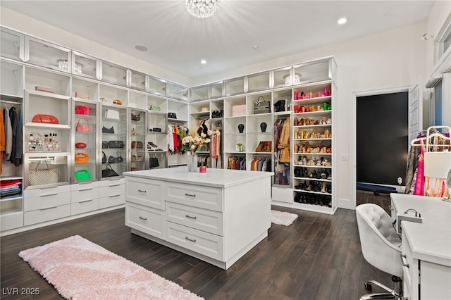 walk in closet with dark hardwood / wood-style flooring