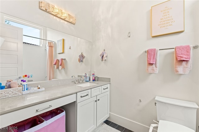 bathroom featuring vanity, toilet, and walk in shower