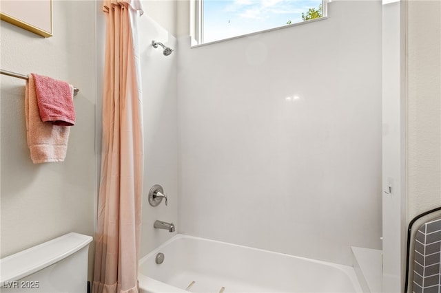 bathroom with shower / bath combo and toilet