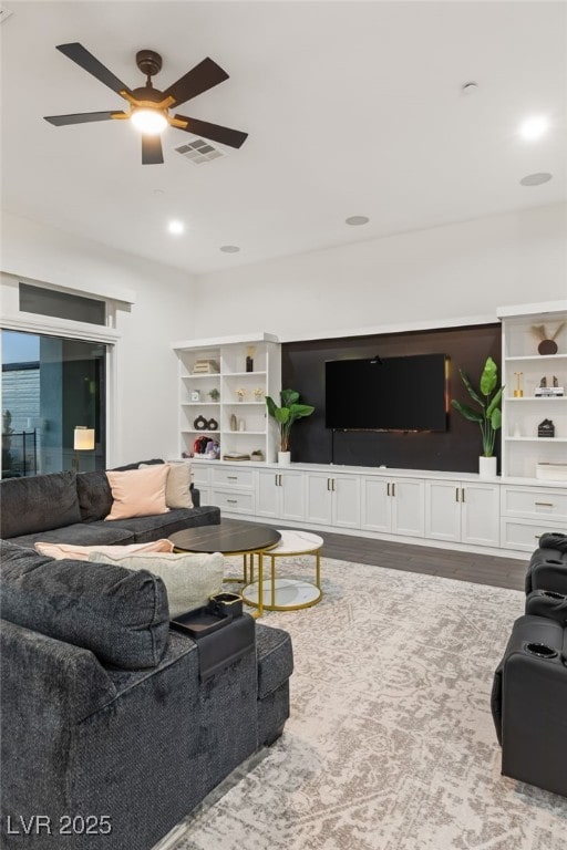 living room featuring hardwood / wood-style flooring and ceiling fan