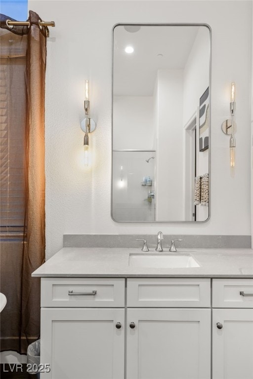 bathroom with vanity and a shower