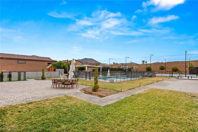 view of swimming pool with a yard and a patio