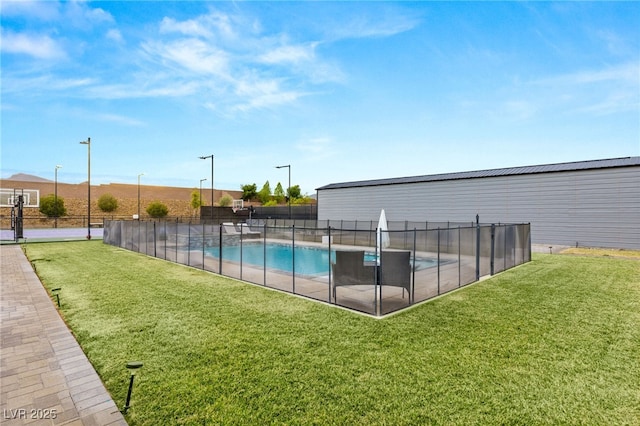 view of swimming pool with a yard