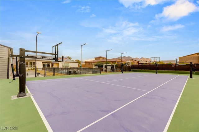 view of tennis court with basketball hoop