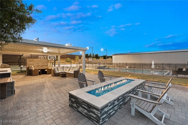 view of patio featuring an outdoor living space with a fire pit