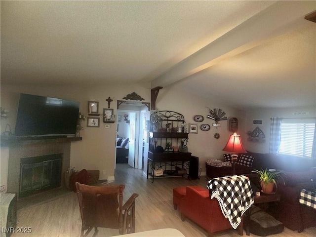 living room featuring beamed ceiling and wood-type flooring