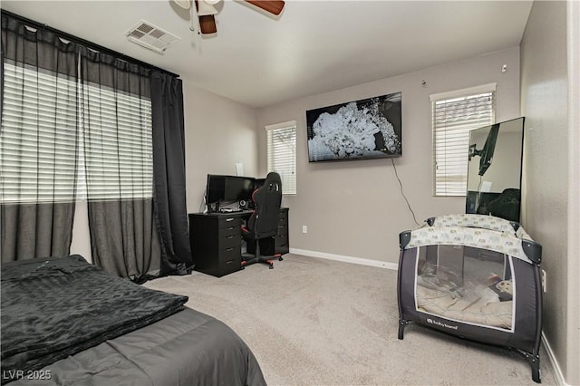 bedroom featuring ceiling fan, carpet, and multiple windows