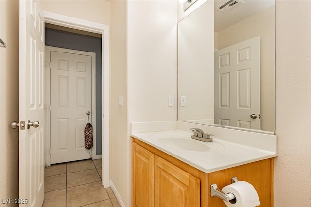 bathroom featuring baseboards, vanity, visible vents, and tile patterned floors