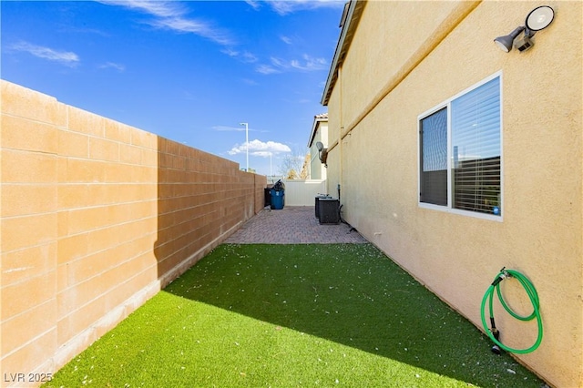 view of yard featuring cooling unit and a fenced backyard