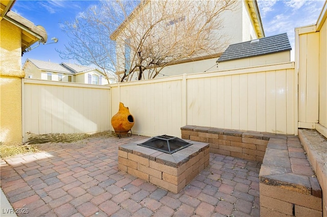 view of patio / terrace featuring a fenced backyard and a fire pit