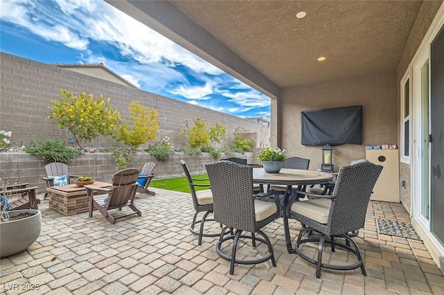 view of patio featuring a fire pit