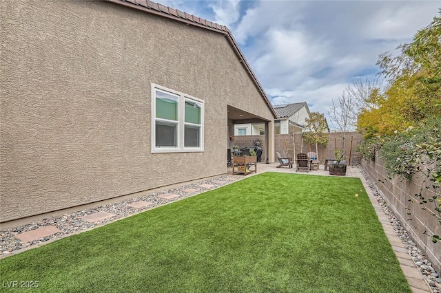 view of yard with a patio and a fire pit