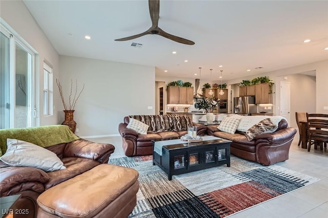 living room featuring light tile patterned flooring and ceiling fan