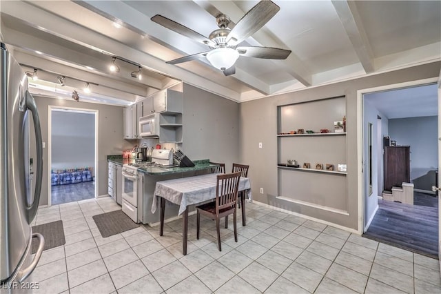 kitchen featuring beam ceiling, ceiling fan, light tile patterned floors, and white appliances